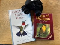 Birding kit with binoculars, book Birding Basics, and book Birds of Michigan